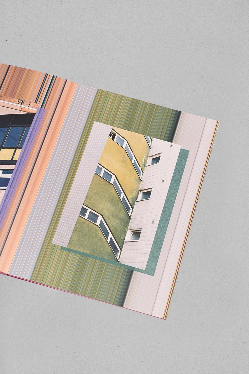 Open pages of Palazzi photobook showing architectural illustration with yellow and green building facade against striped background